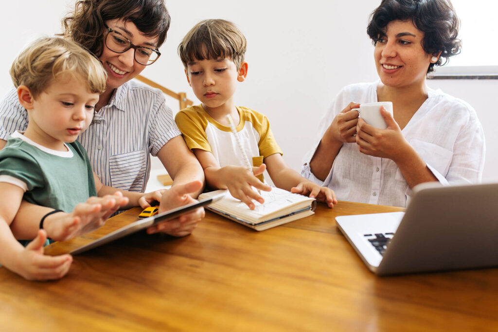 Family sitting at kitchen table with toys