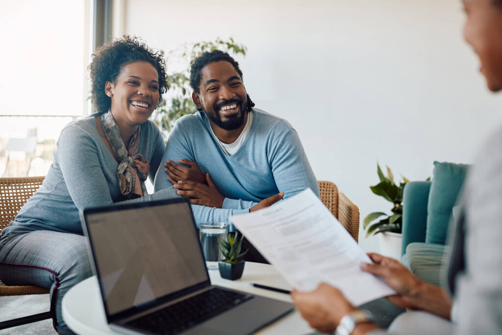 A couple is browsing renters insurance options with a Quaint Oak Insurance agent