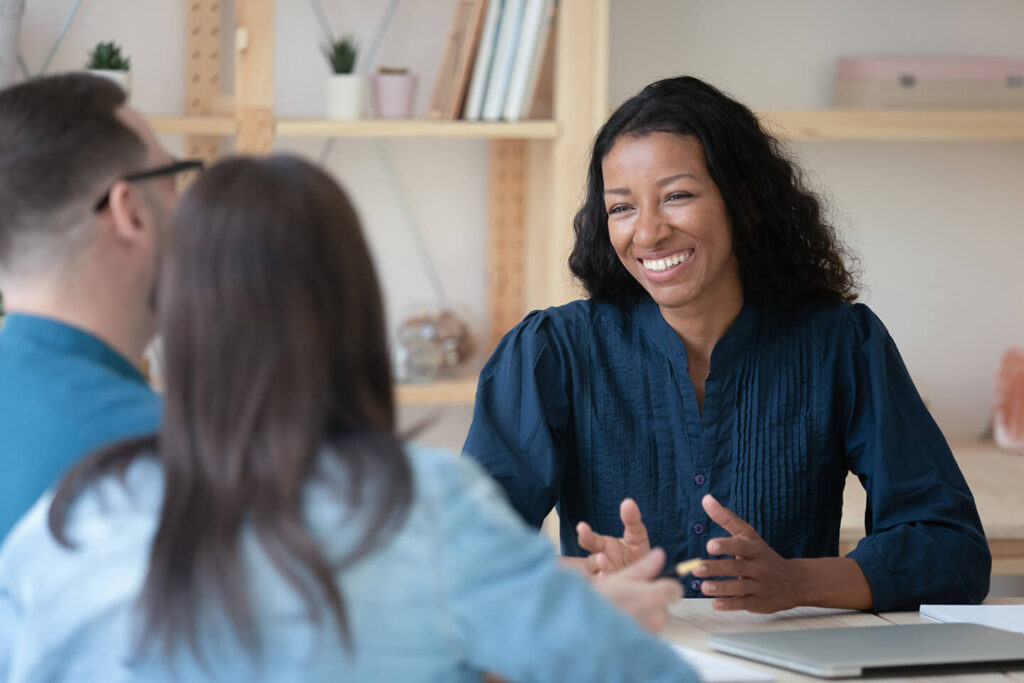 Couple talking to Quaint Oak Insurance agent about life insurance policies