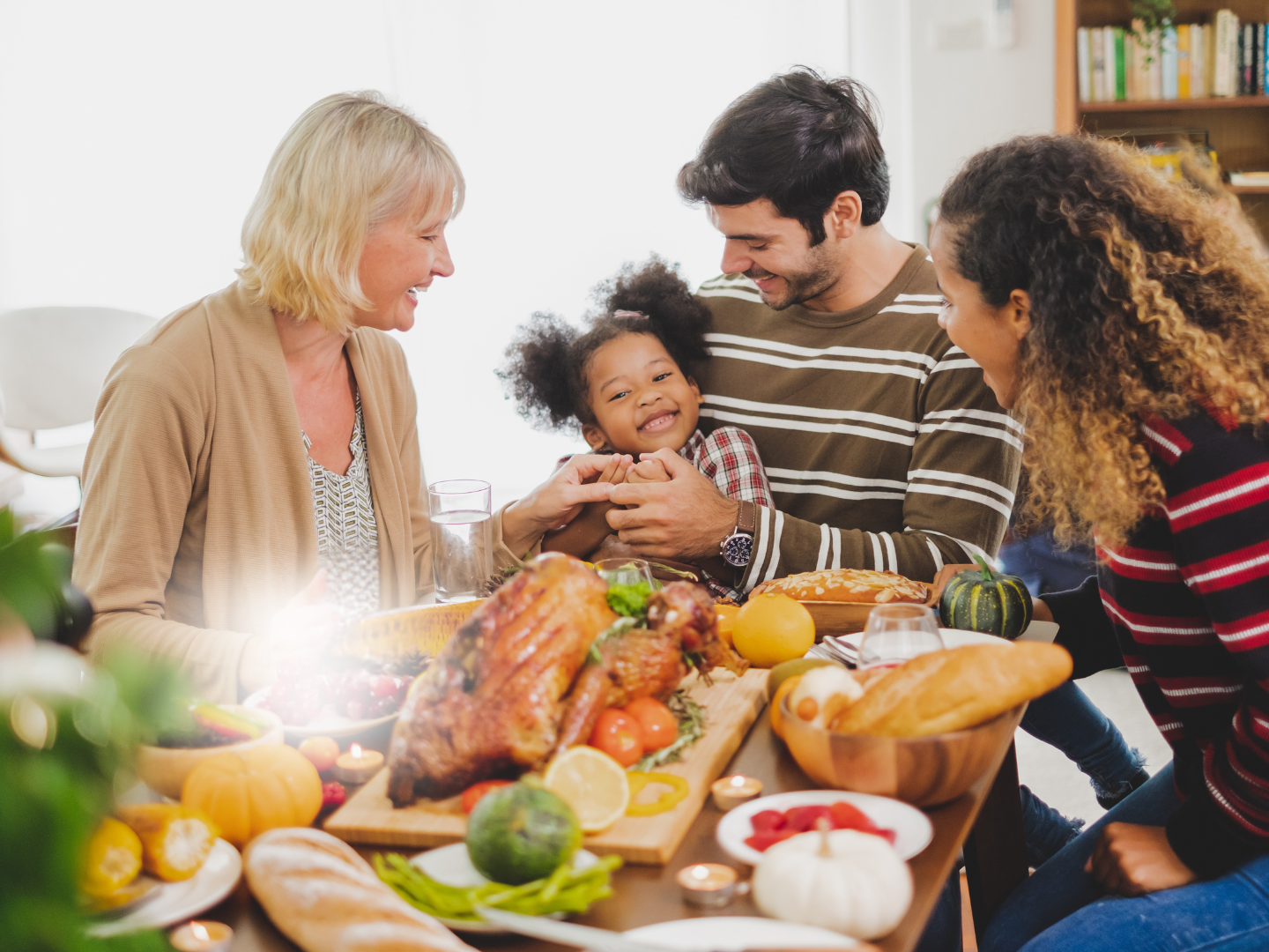 friends and family getting together to share a meal during the holiday season after the host learned more about liability insurance for holiday parties