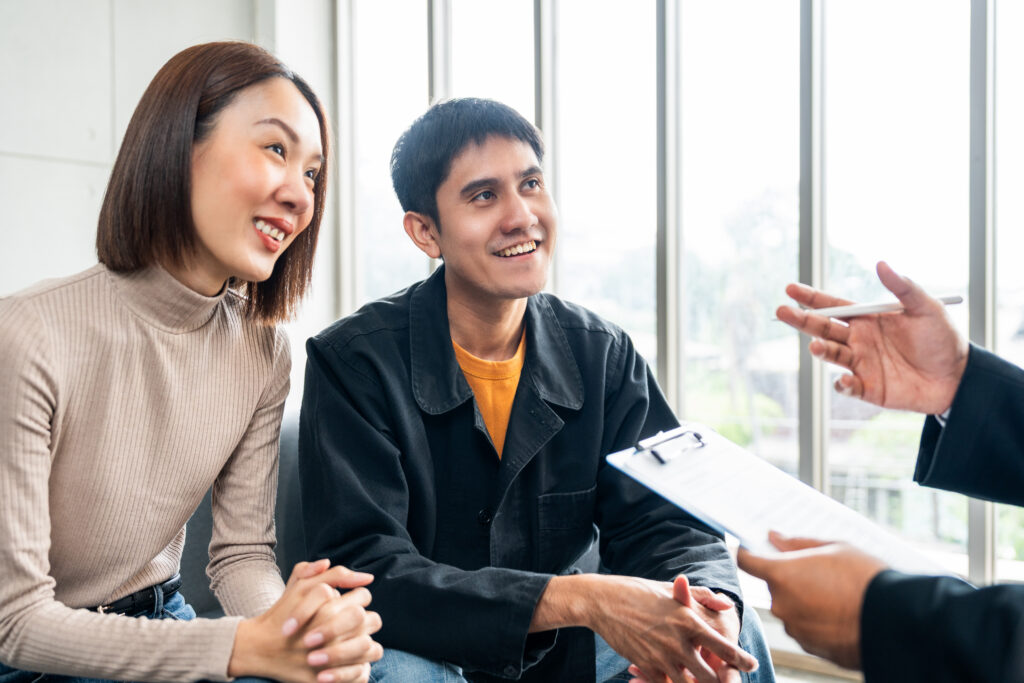 Young couple meeting with insurance professional about the top reasons for an insurance review